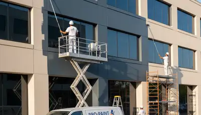 Professional commercial painters finishing office exterior in Peoria, IL for a durable, polished look